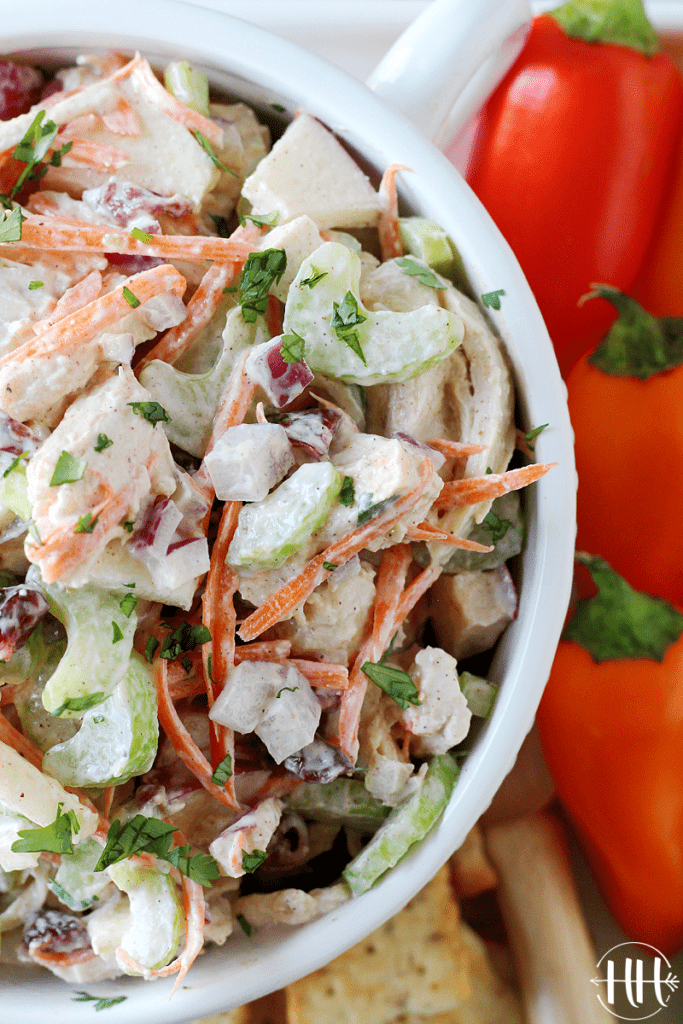 Overhead photo of leftover turkey salad in a white bowl with mini red bell peppers.