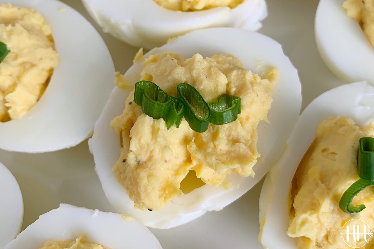 Up close photo of easy deviled eggs topped with green onion.