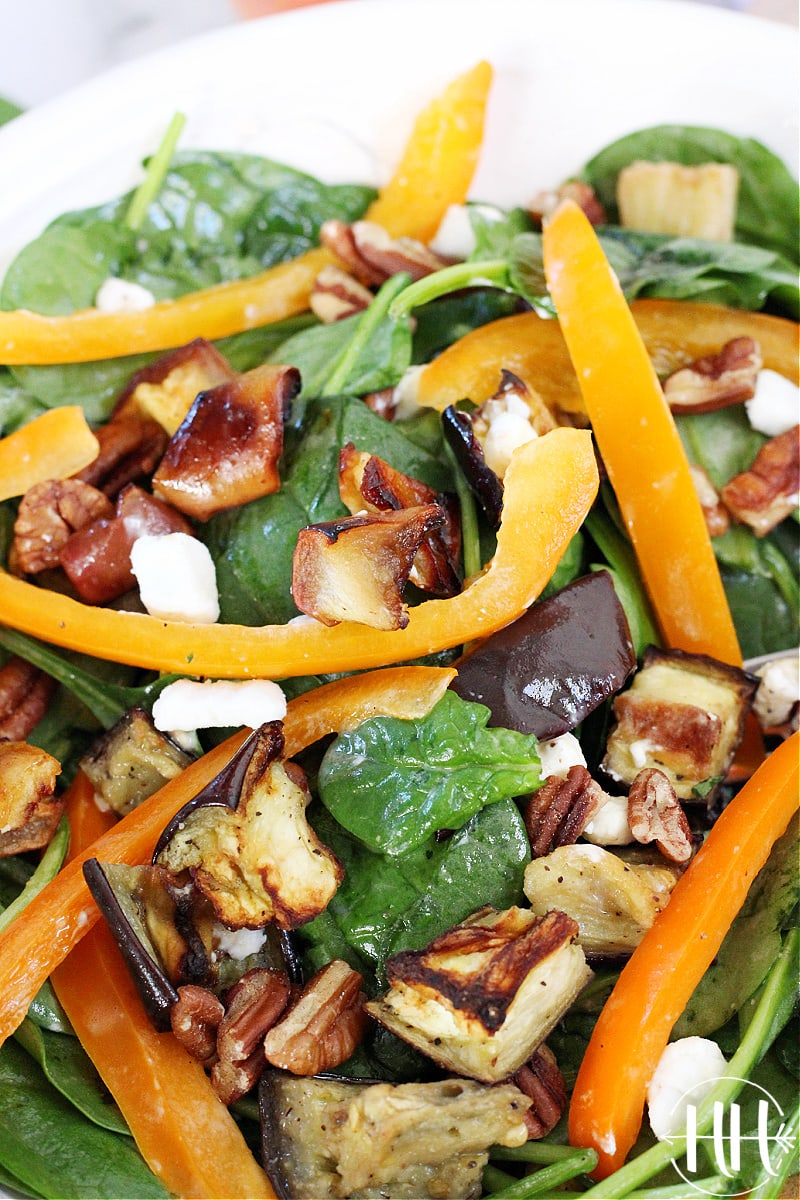 Up close shot of cubed baked eggplant in a salad tossed with a homemade dressing. 