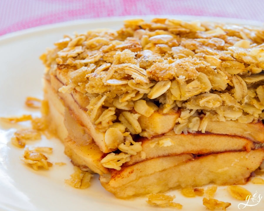 A slab of Gluten-Free Apple Crisp from HappiHomemade on a white plate.