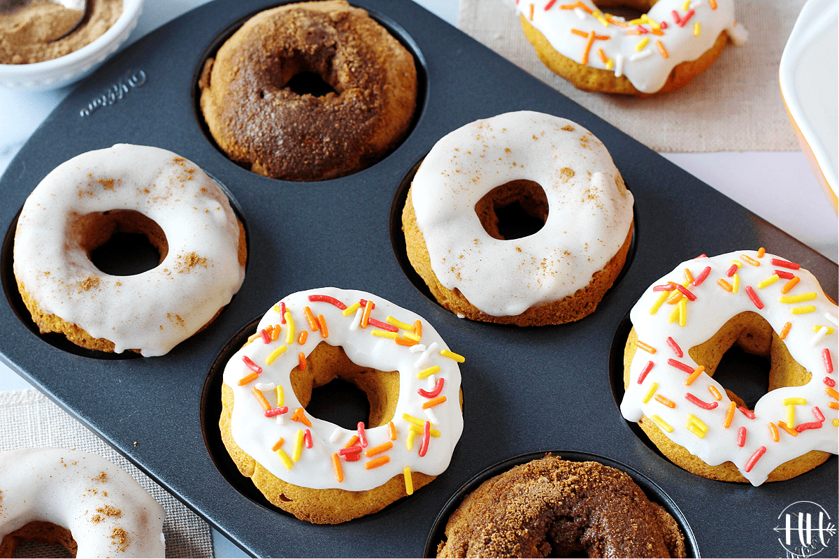 A donut pan filled with dairy free frosted, sugar free glazed, and sugar coated pumpkin donuts.