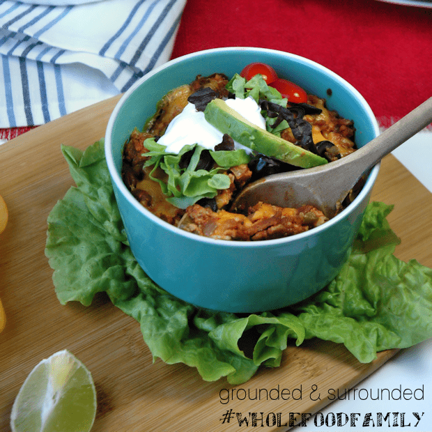 A cute bowl of Mexican Lasagna consisting of tortillas, meat, and cheese.