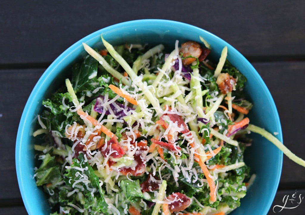 Gluten free kale salad with homemade dressing topped with Parmesan cheese.