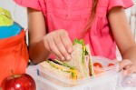 Healthy School Lunch Ideas with a girl eating her lunch.