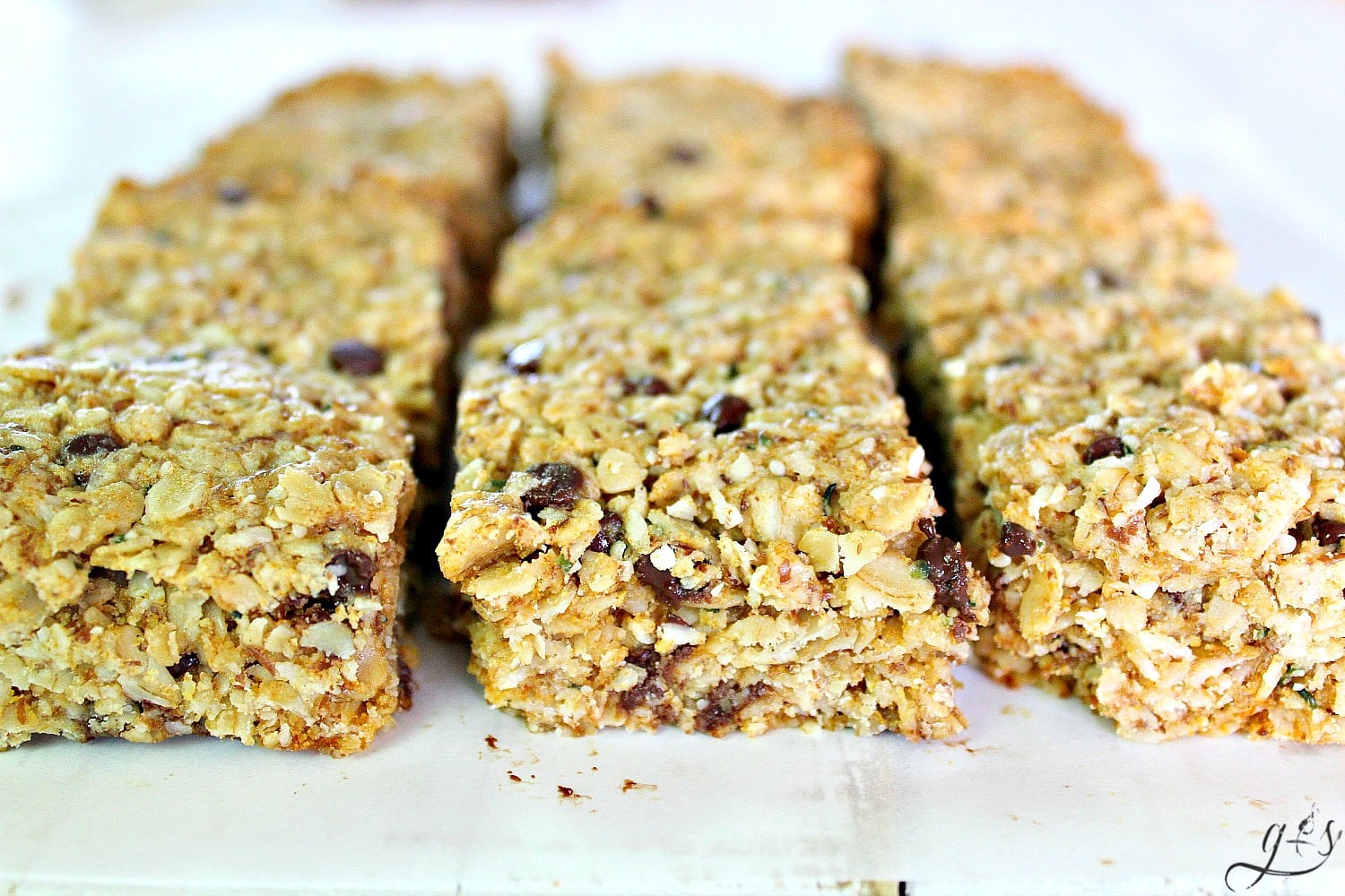 These Fit & Frugal Granola Bars are made with healthy gluten free ingredients to create chewy granola bars you feel good about feeding your kids. This homemade recipe is a perfect snack or addition to any school lunch. They are packed with superfoods like ground flax seeds, hemp seeds and coconut! But any add-ins will work! We never skip the chocolate chips but the possibilities are endless. Look no further, you have found the BEST granola bar recipe on Pinterest!