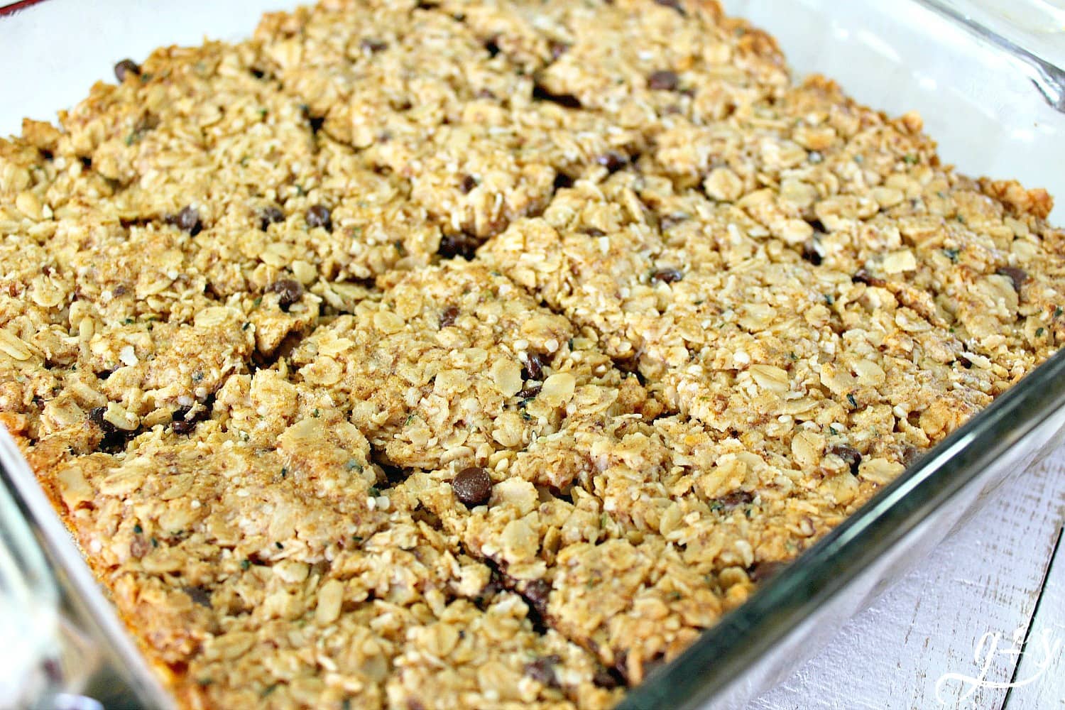 These Fit & Frugal Granola Bars are made with healthy gluten free ingredients to create chewy granola bars you feel good about feeding your kids. This homemade recipe is a perfect snack or addition to any school lunch. They are packed with superfoods like ground flax seeds, hemp seeds and coconut! But any add-ins will work! We never skip the chocolate chips but the possibilities are endless. Look no further, you have found the BEST granola bar recipe on Pinterest!