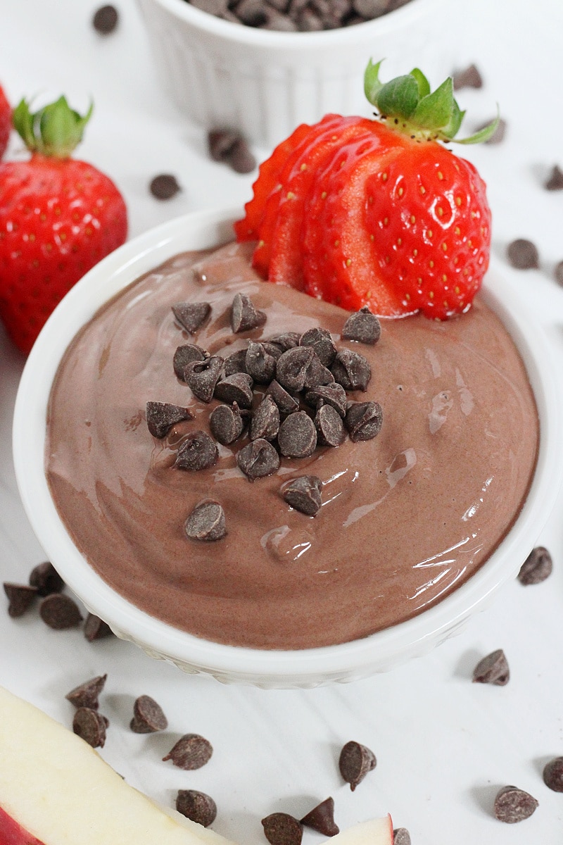 Up close photo of high protein chocolate dip with strawberry dippers.
