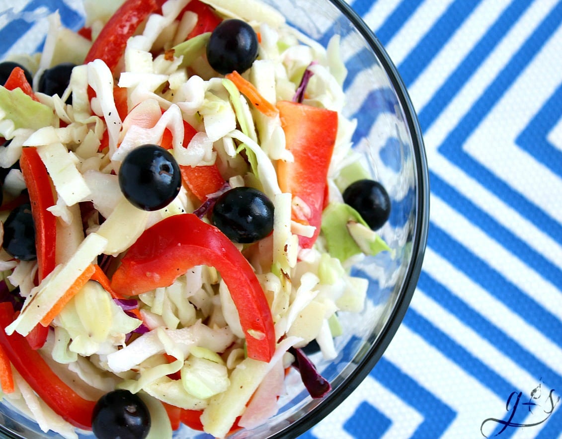 This healthy and easy RED, WHITE & BLUE Slaw Salad is the perfect addition to any summer BBQ! July 4th and Memorial Day are the perfect holidays for this festive and crowd-pleasing salad. This patriotic homemade salad is packed with whole foods such as crunchy cabbage, sweet blueberries, delicious red bell pepper, and tart apple. Bring the BEST clean eating and gluten-free coleslaw recipe to your next potluck! 