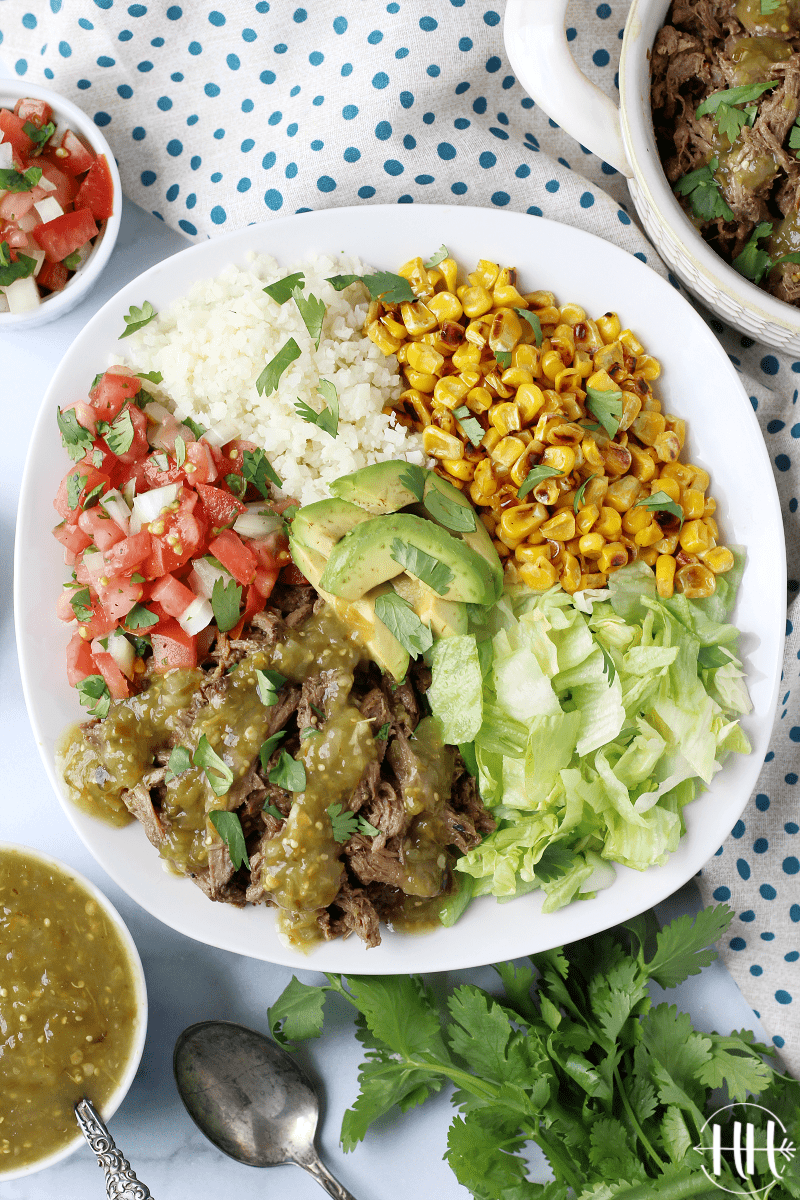 Crock Pot Salsa Verde Shredded Beef | This is the best slow cooker recipe I have found to cook beef roasts in the crockpot! Use the meat in gluten free and easy tacos, dairy free burritos, keto riced cauliflower bowls, Mexican sandwiches or on low carb salads. Simple meat recipes like this are my go-tos when I need healthy and clean eating comfort food. Easy and delicious dinners like this are made for families of all sizes, any day of the week (not just Sunday dinners), all year long! 