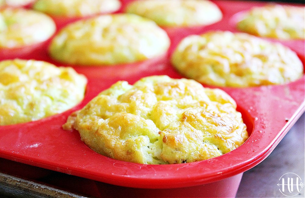 Healthy frittata muffins cooling in a red silicone muffin tin.