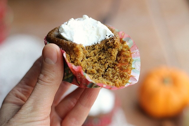 Cute little Pumpkin Pie Cupcakes from Oatmeal with a Fork topped with whipped cream. 