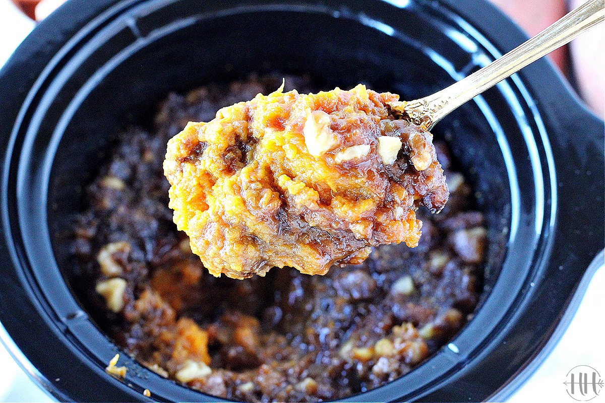 Spoonful of Skinny Sweet Potato Casserole cooked in a crock pot for Thanksgiving.