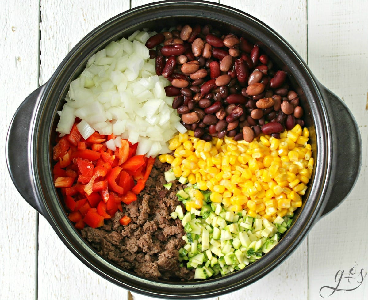 Whole Food Family Recipes: Taco Soup ingredients in sections in a large black Dutch oven. 