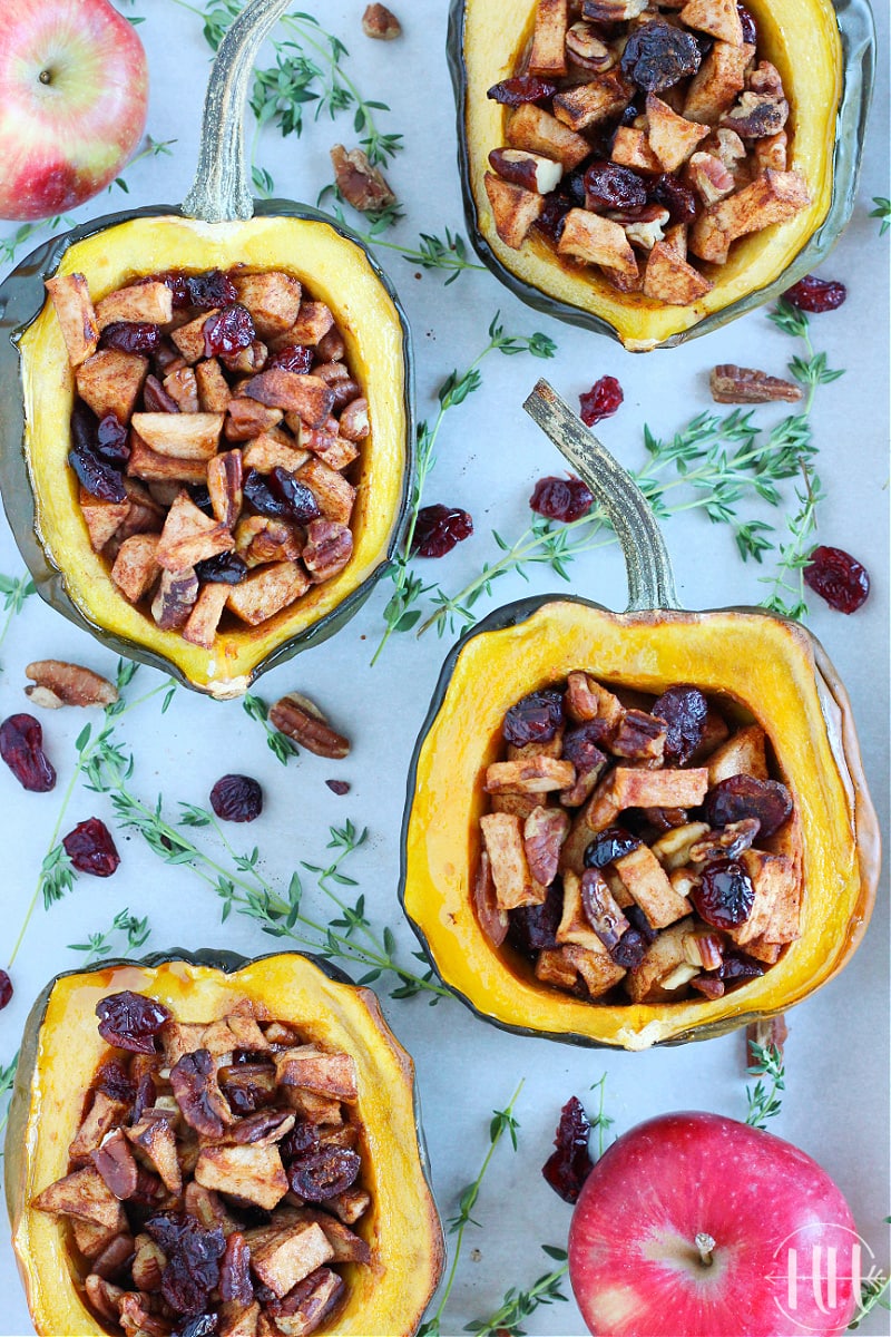 Halved acorn squashes filled with apples and dried cranberries.