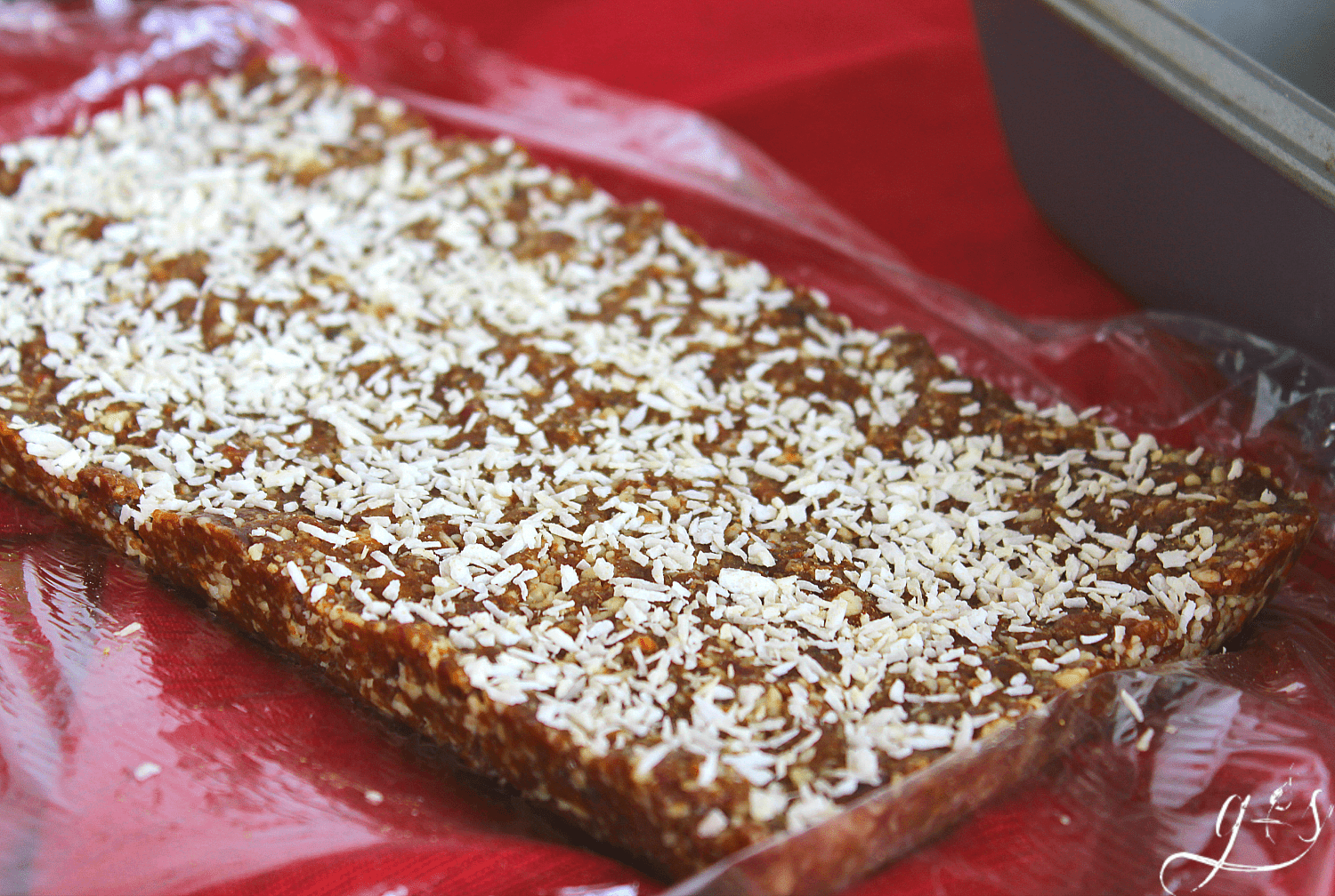 A thick slab of gingerbread energy bite dough ready to be sectioned. 