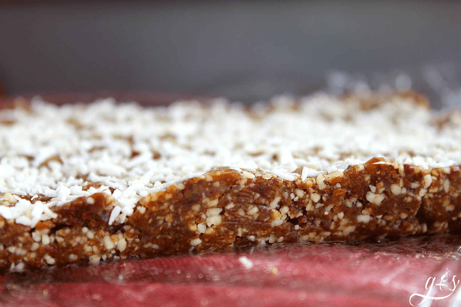 Up close shot of a pan of Christmas energy bites ready to be cut into squares.