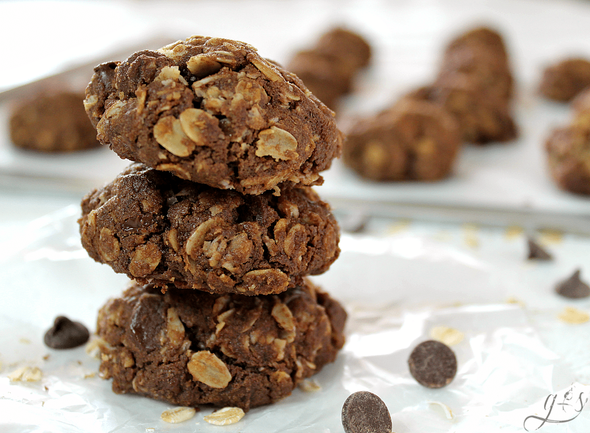 Three double chocolate oatmeal cookies stacked on top of each other.