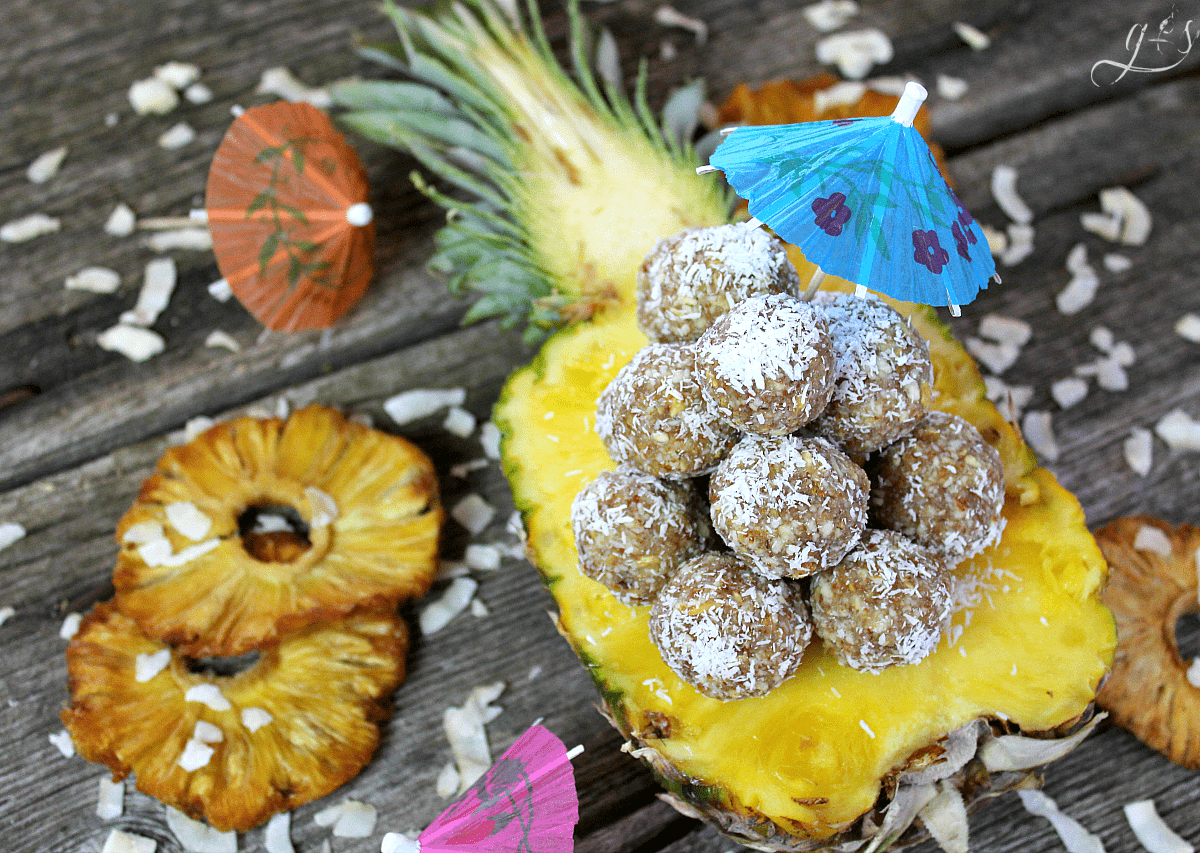 The BEST 4 Ingredient Pina Colada Energy Bites | This easy no bake recipe will become your favorite healthy snack, they taste just as dreamy as the cocktail drinks! Gluten-free dried pineapple, almonds, coconut, and vanilla combine to create a clean eating, Paleo, 21 Day Fix & Whole30 approved, and vegan non-alcoholic recipe that is perfect for kids and adults alike. Take on your next trip to the beach, hike, or pack for lunch! If serving only adults, add a little rum to the mixture! 