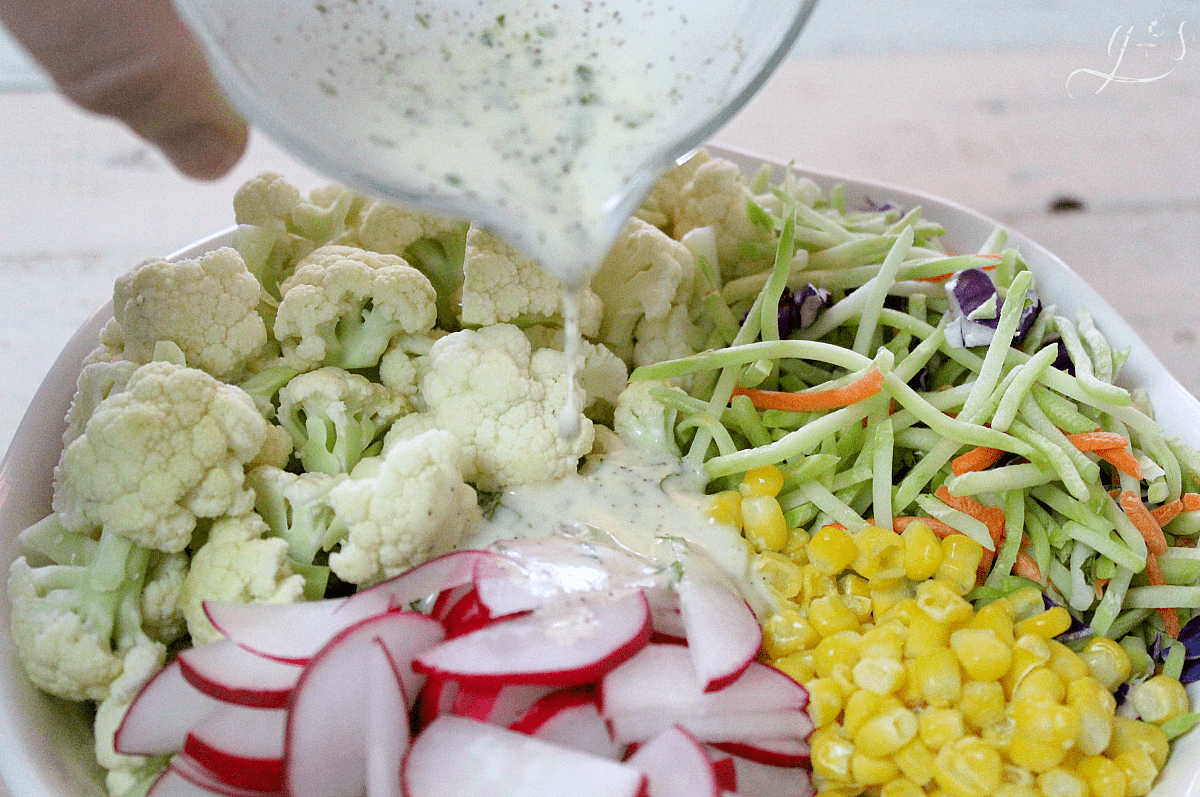 The BEST Cauliflower & Broccoli Slaw Salad | Say hello to the newest healthy and gluten free salad and homemade dressing recipes on the block! Add fresh radish and corn(fresh or frozen) to the main ingredients. Then a little clean eating mayo, fresh chopped basil, and a couple other easy pantry ingredients to the sauce. Eat this as a vegetarian meal for dinner and lunch or to feed a crowd. Spring and summer are my favorite seasons to eat this low carb and vegan side salad!