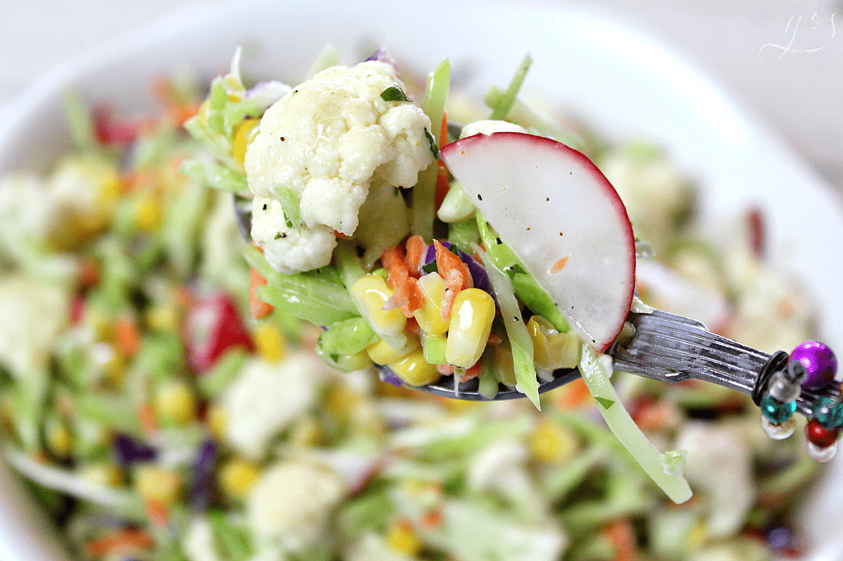 Pretty spoon with a colorful slaw salad and radishes