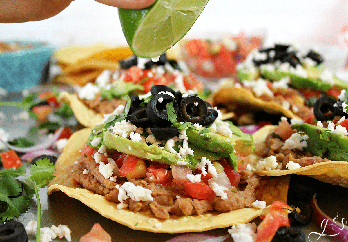 Healthy vegetarian tostadas drizzled with fresh lime juice.