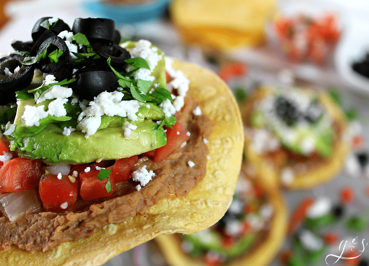 Simple tostadas made with vegetarian ingredients topped with blacked olives.
