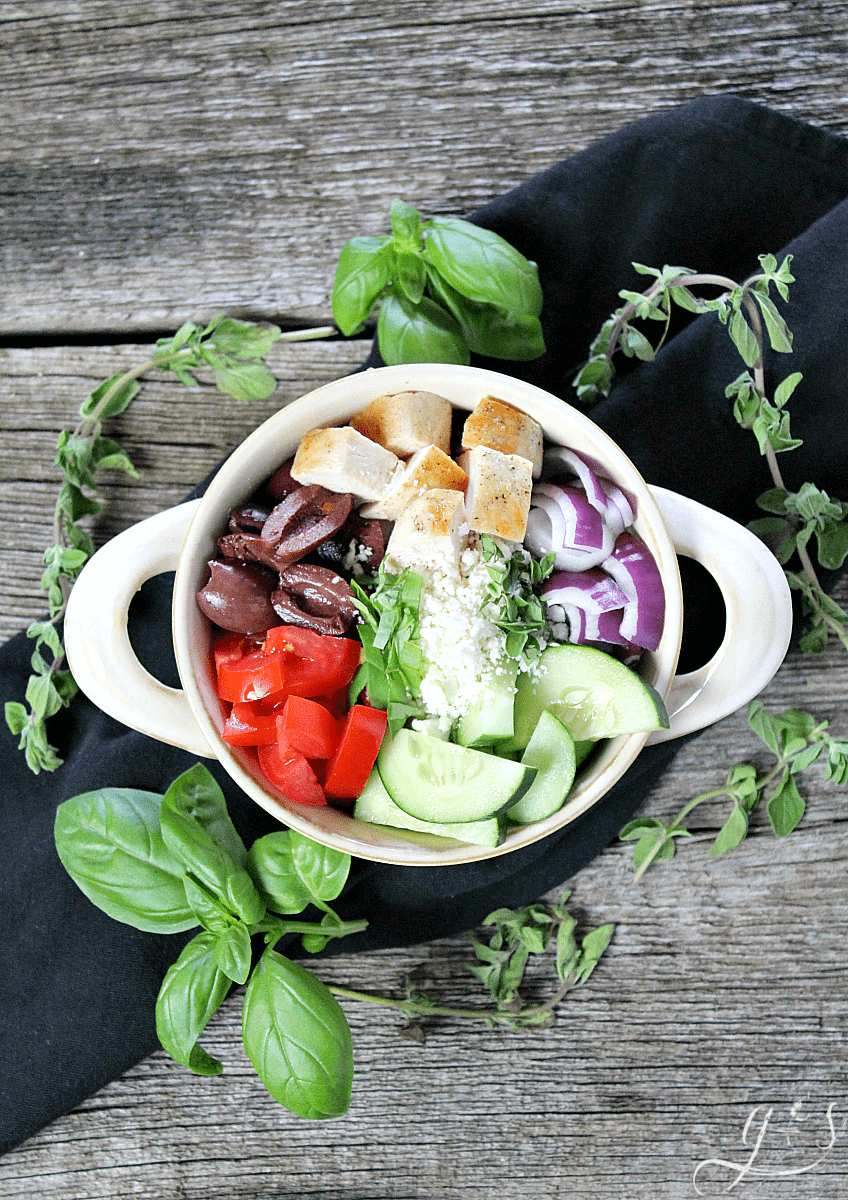 The BEST Skinny Greek Salad | This healthy and clean eating salad is easy, authentic, and ahhhhmazing! Throw together all the veggies, grilled chicken, herbs, cheese, and olives then go crazy with the dressing. Use balsamic vinegar, extra virgin olive oil, and salt and pepper to make this a truly delicious dinner or gluten-free lunch. Add cooked quinoa to make it vegetarian or omit the chicken and quinoa and serve as a chopped salad side dish. 21 Day Fix | Vegan Meal Version | Simple