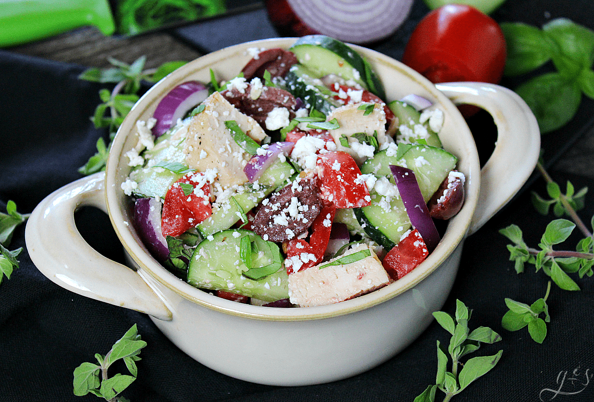 The BEST Skinny Greek Salad | This healthy and clean eating salad is easy, authentic, and ahhhhmazing! Throw together all the veggies, grilled chicken, herbs, cheese, and olives then go crazy with the dressing. Use balsamic vinegar, extra virgin olive oil, and salt and pepper to make this a truly delicious dinner or gluten-free lunch. Add cooked quinoa to make it vegetarian or omit the chicken and quinoa and serve as a chopped salad side dish. 21 Day Fix | Vegan Meal Version | Simple