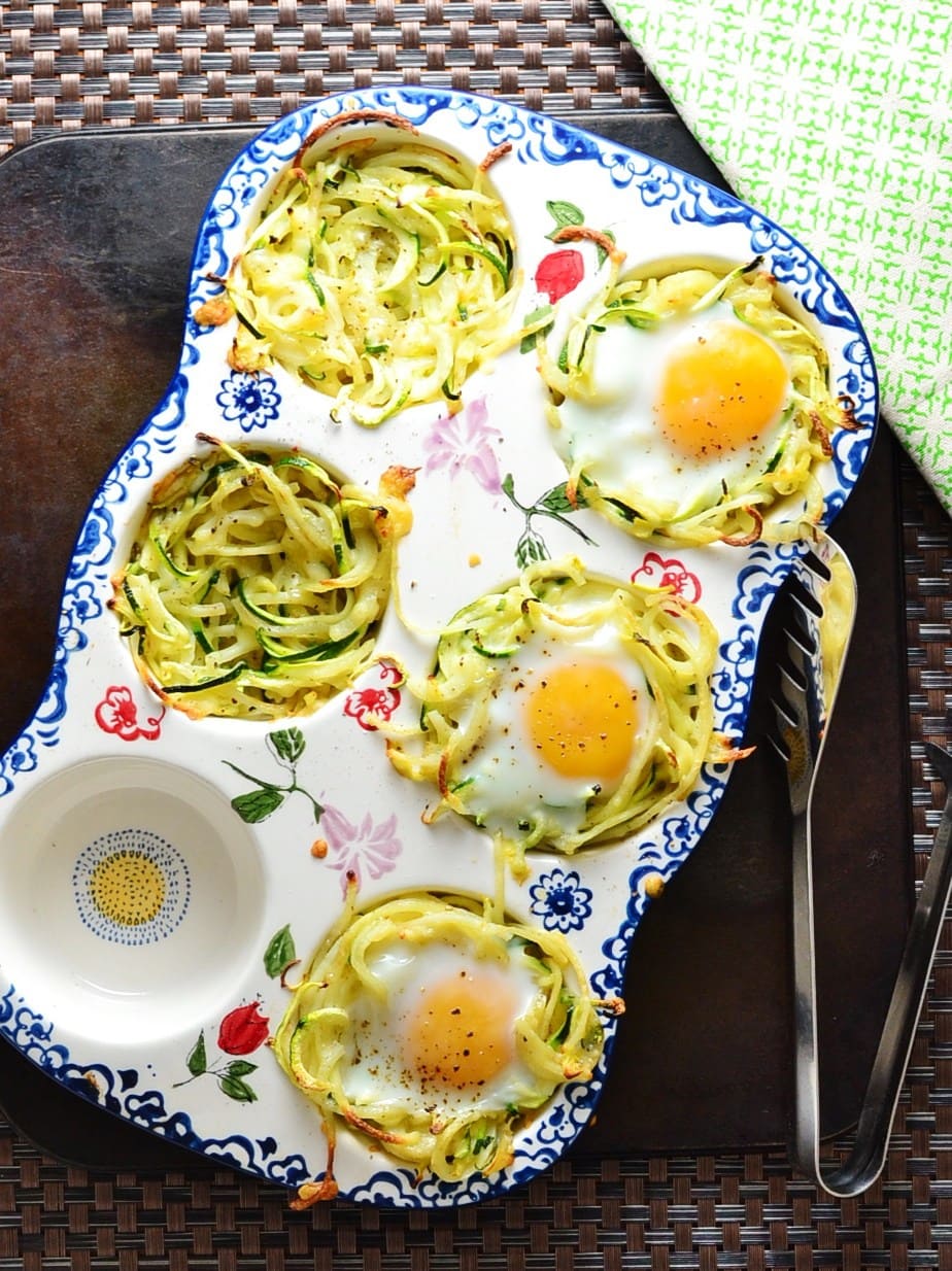Potato zoodle egg nests in a ceramic muffin pan.