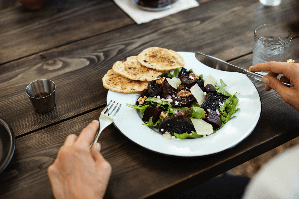 A salad on a wood table to get your digestive system healthy.