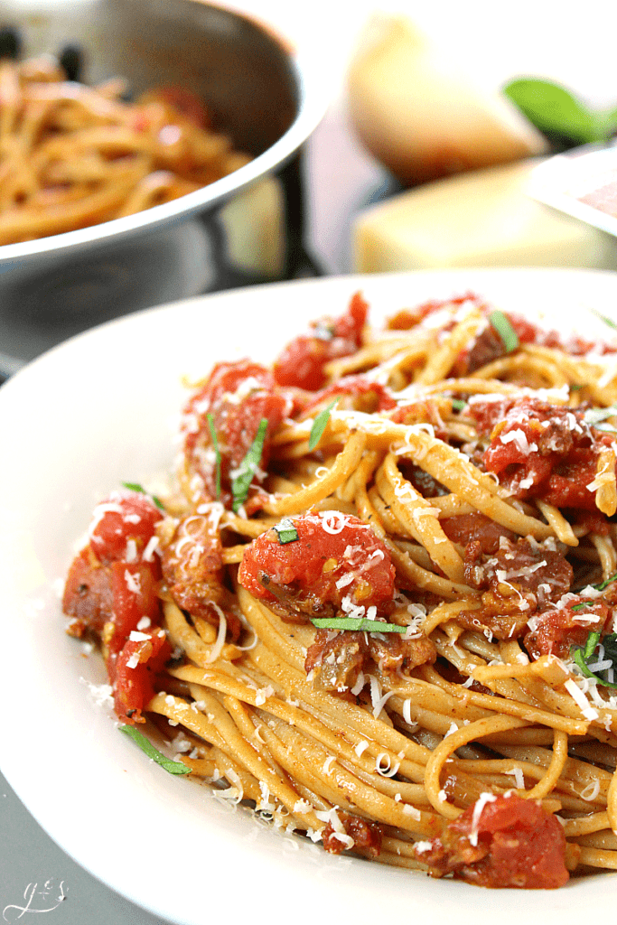 The BEST Amatriciana and Linguine | This easy pasta sauce recipe uses bacon, tomatoes, onions, garlic, and red chile pepper flakes to make a unique meal atop linguine, bucatini, spaghetti, or penne. Dinners like this can be made healthier, gluten-free, and clean eating by using spaghetti squash or sauteed veggies. Comfort food at it's finest with this simple and traditional Roman and Italian dish!