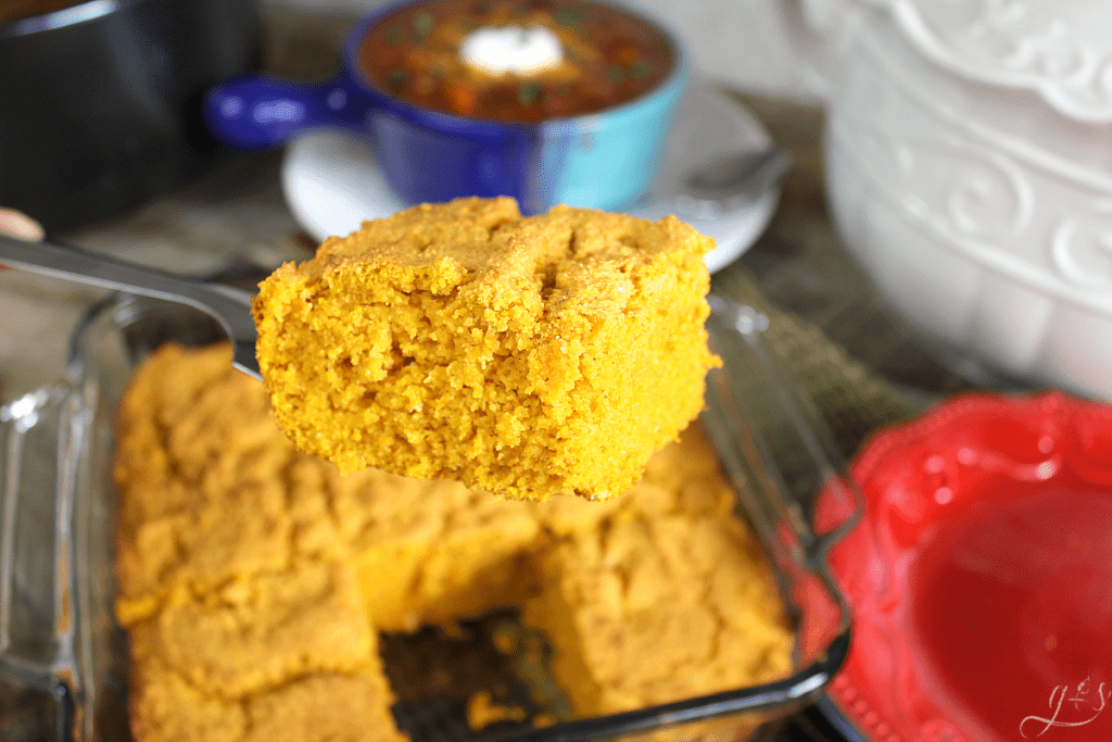 The BEST Gluten Free Pumpkin Cornbread | This easy and sweet clean eating recipe will make all your dreams come true this fall! Top this healthy side dish with butter, honey, or maple syrup. Serve alongside soup, chili, or stew for a comforting and skinny meal. You can easily make this batter into muffins too! 