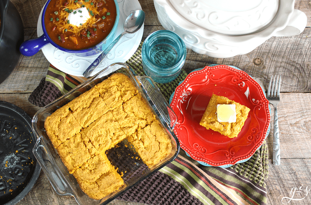 birds eye view of a pan of cornbread with a bowl of chili.