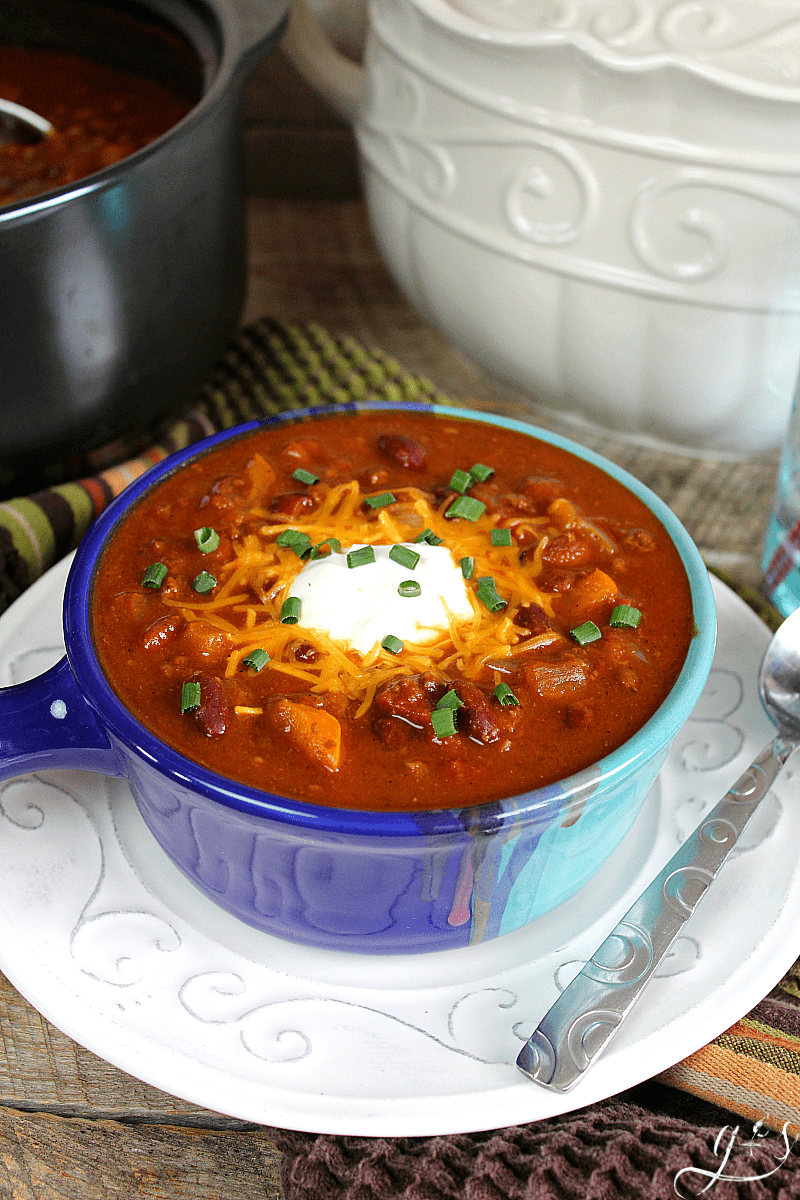 Autumn inspired chili topped with sour cream, shredded cheese and green onion.