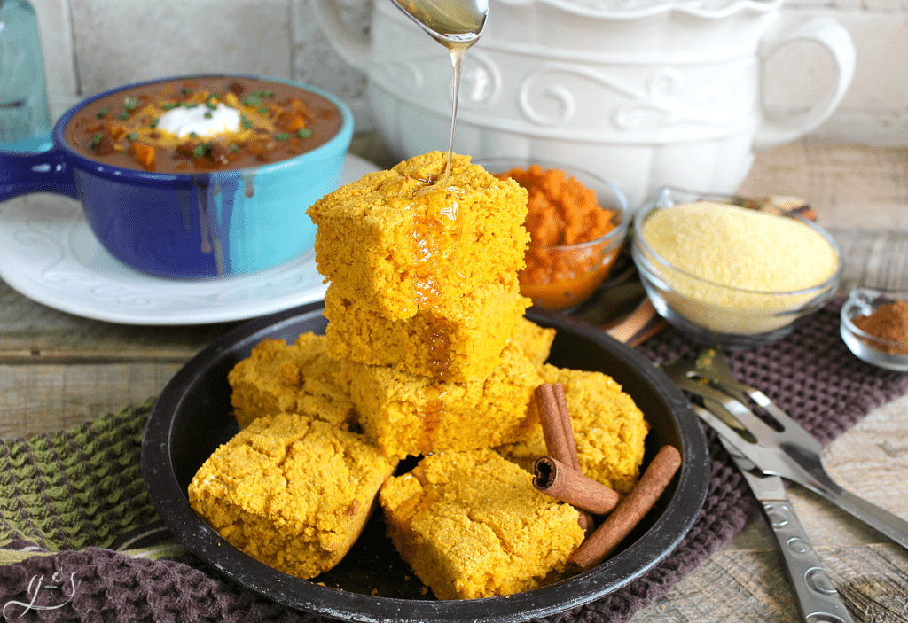 The BEST Gluten Free Pumpkin Cornbread | This easy and sweet clean eating recipe will make all your dreams come true this fall! Top this healthy side dish with butter, honey, or maple syrup. Serve alongside soup, chili, or stew for a comforting and skinny meal. You can easily make this batter into muffins too! 