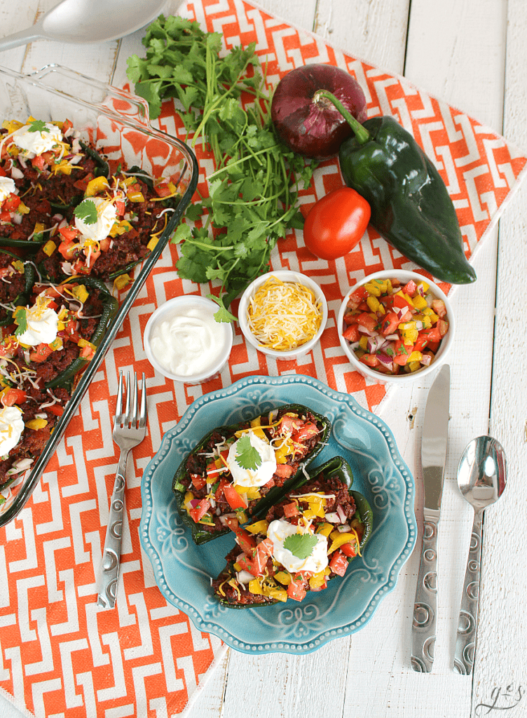The BEST Clean Eating Stuffed Poblano Peppers | This easy Mexican dinner is healthy, gluten-free, low carb, and keto friendly. Use any ground meat (beef, buffalo, turkey, venison), shredded cheese, and top with a fresh homemade bell pepper salsa. Think of these as a healthy take on tacos by adding plain Greek yogurt (sour cream), avocado, and additional salsa to this delicious recipe. Make Paleo by omitting the cheese or use beans in place of the meat to make it vegetarian!