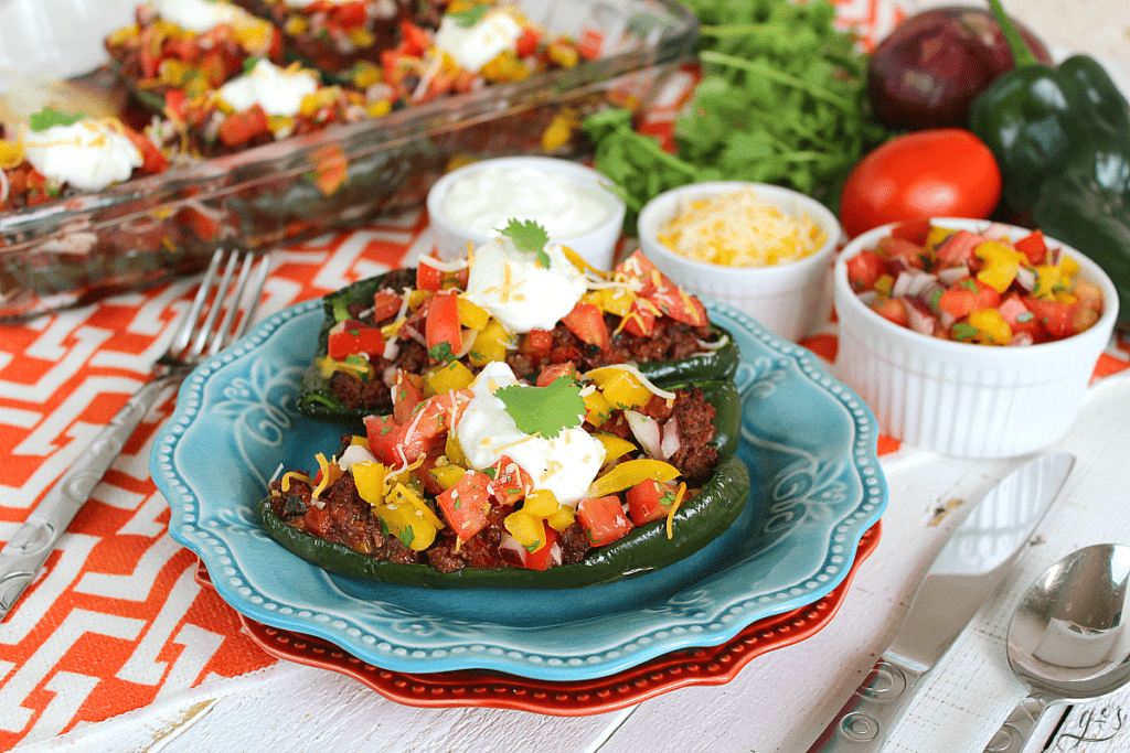 Pretty plates filled with poblanos stuffed with clean eating ingredients.