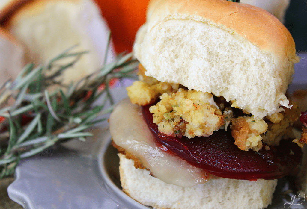 The BEST Thanksgiving Leftover Sliders | Whether you want to enjoy all the flavors of Thanksgiving with leftovers on Black Friday or enjoy this recipe in the summer, I've got you covered. Use a turkey burger or leftover turkey, stuffing, provolone cheese, cranberry sauce, and mayo. Add mashed potatoes and gravy too! This is the best warm sandwich to enjoy with friends, family, and the kids! #holidays #burgers #leftovers