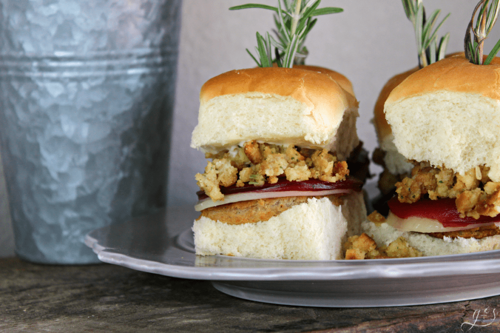 The BEST Thanksgiving Leftover Sliders | Whether you want to enjoy all the flavors of Thanksgiving with leftovers on Black Friday or enjoy this recipe in the summer, I've got you covered. Use a turkey burger or leftover turkey, stuffing, provolone cheese, cranberry sauce, and mayo. Add mashed potatoes and gravy too! This is the best warm sandwich to enjoy with friends, family, and the kids! #holidays #burgers #leftovers