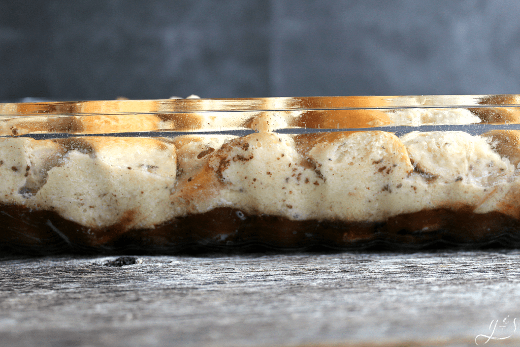 Layers on goodness in a clear glass pan. Caramel layer on the bottom with eggy soaked bread on top.