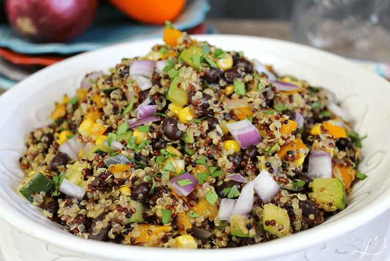 Up close photo of one-pot southwest quinoa salad in a bowl topped with red onion.