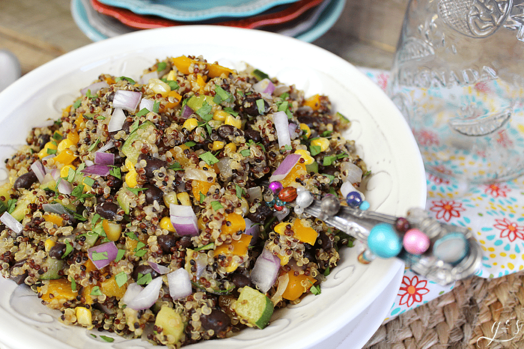 Pretty southwestern quinoa salad with a beaded spoon.