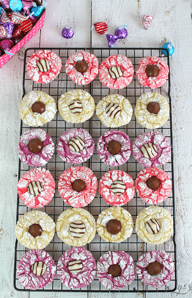 Overhead view of vibrant pink, purple, and white holiday cookies for Valentine's Day. 