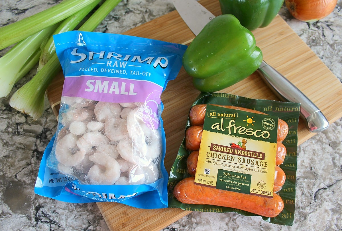 A bag of frozen small shrimp and smoked andouille chicken sausage.