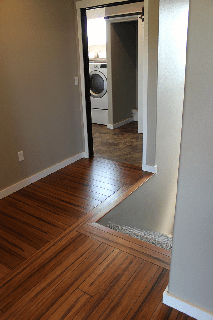 A wood floor hallway in need of a rustic stair banister.