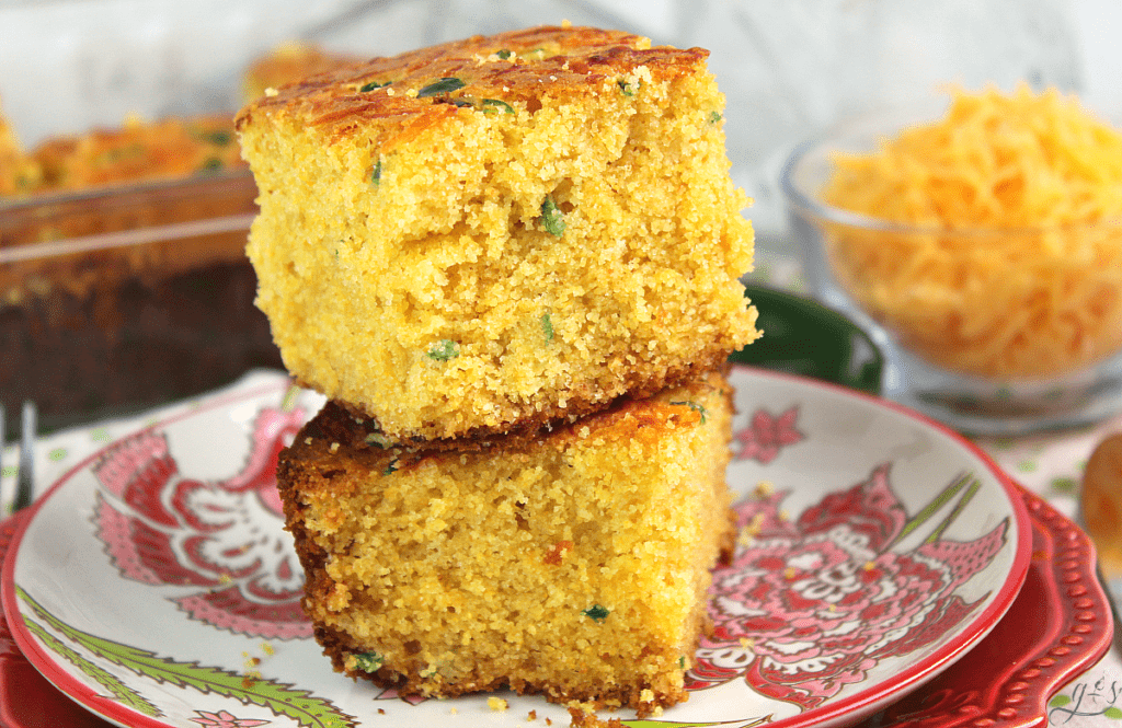 Up close view of cheesy jalapeno cornbread with shredded cheddar cheese and diced jalapeno. 