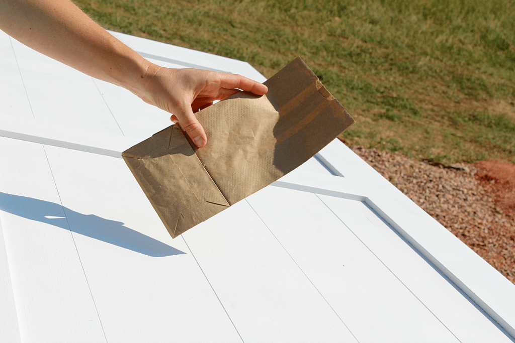 Small brown paper bag used to buff out wax on door. 