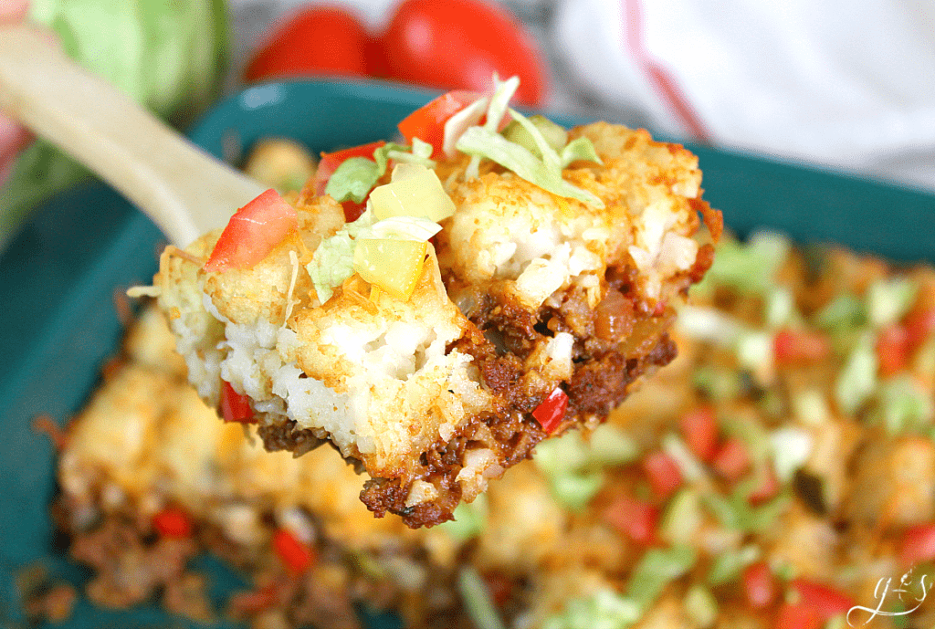 Gluten-Free Cheeseburger Casserole on a wooden spoon ready to be eaten.