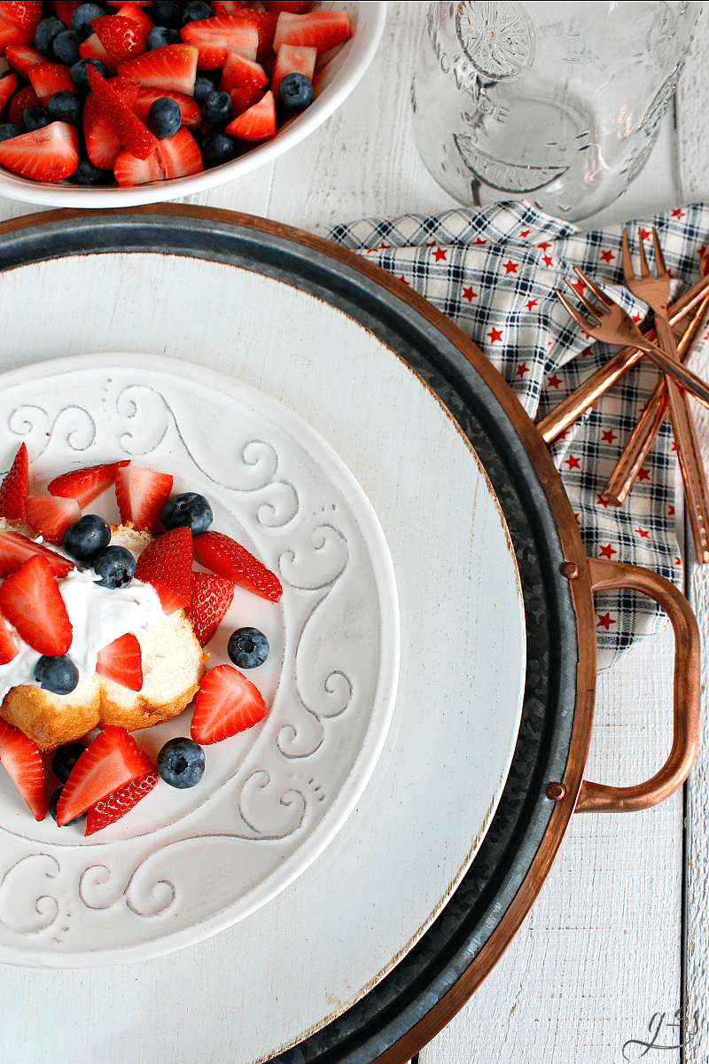 The BEST Patriotic Shortcake | Your July 4th, Memorial Day, and Labor Day parties just got a whole lot better with this easy dessert option! Buy an angel food cake, fresh strawberries, blueberries, and a can of full-fat coconut milk or coconut cream. This healthy dairy-free recipe is the easiest way to have a themed dessert for your next American freedom bbq. Plus, homemade whipped cream is always the best! Patriotic food ROCKS! #summer #dessert #america