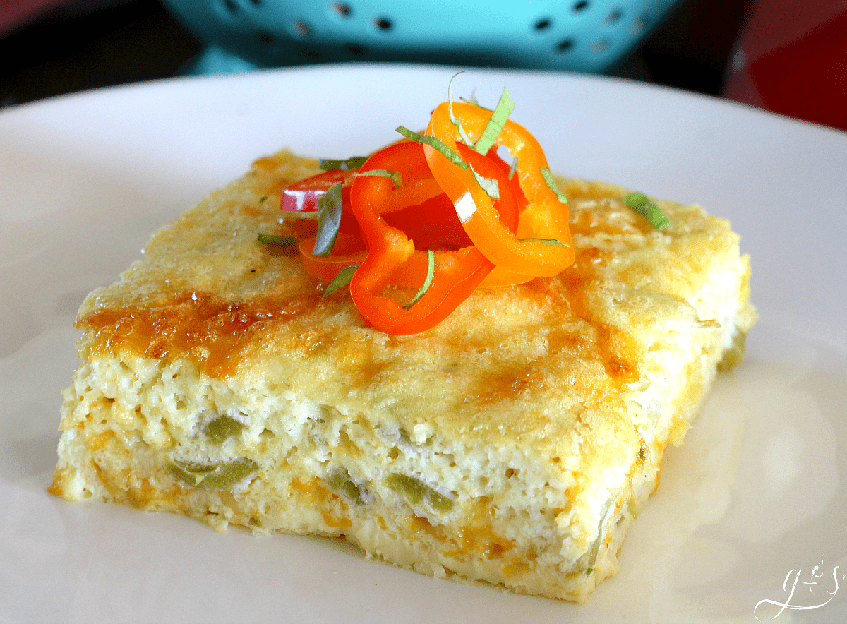 Beautiful shot of a slice of an egg bake using canned green chiles, pepper jack cheese, and oat flour. 